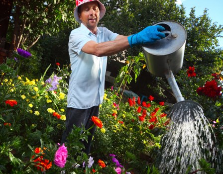 Garden care workers separating green waste from recyclables in an urban yard